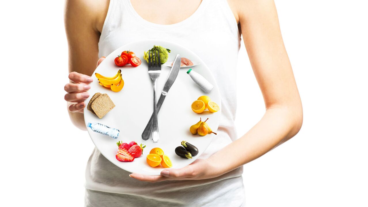 The girl holds a food plate